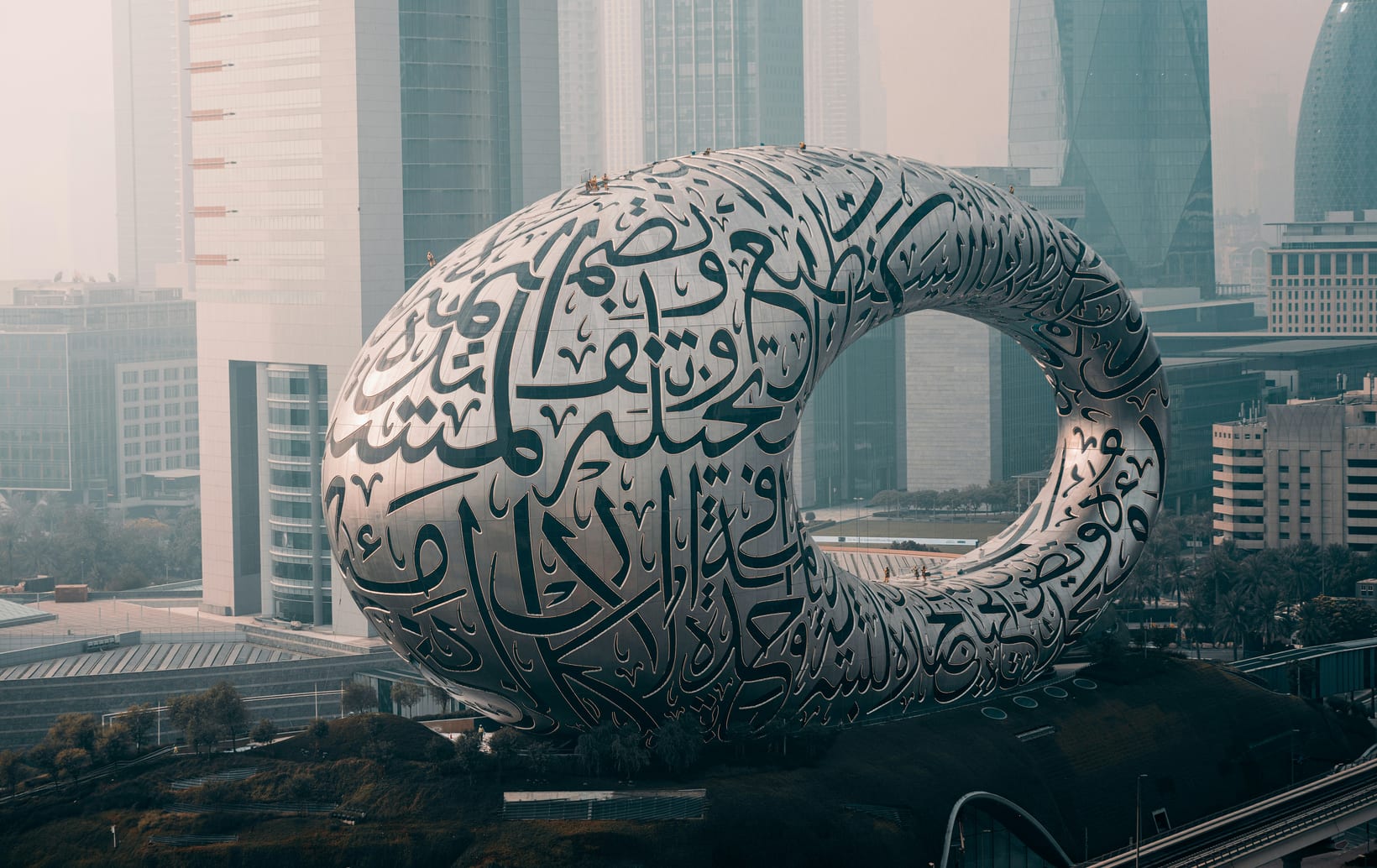The Museum of the Future in Dubai, its steel facade covered in Arabic calligraphy, against the Sheikh Zayed Road skyline.